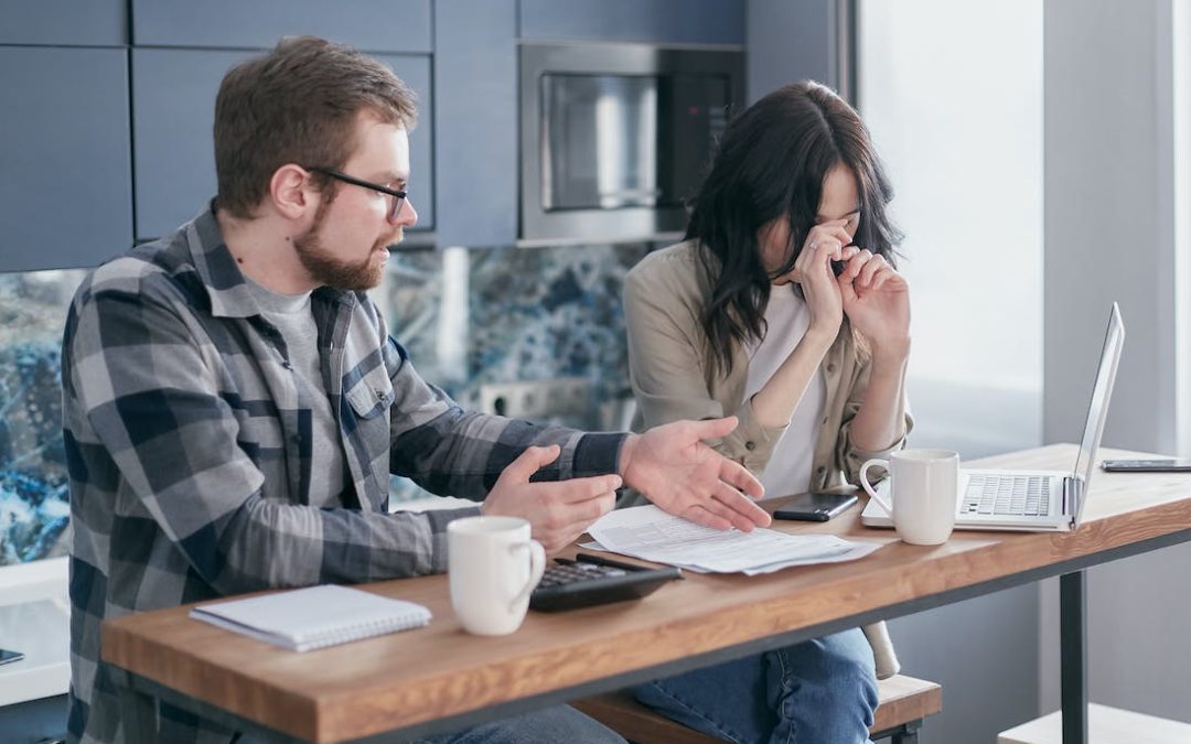 frustrated looking couple getting a divorce now discussing financial settlement