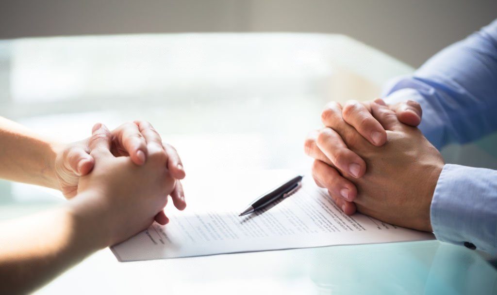 close up of a solicitor and woman discussing separation agreements