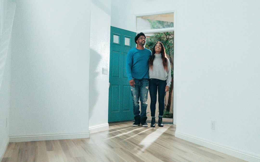 Man and woman inside a house purchasing a property together