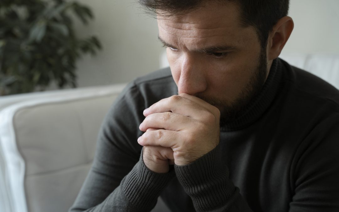 Anxious man at home, a visual representation of the emotional impact amidst the increase in domestic abuse cases