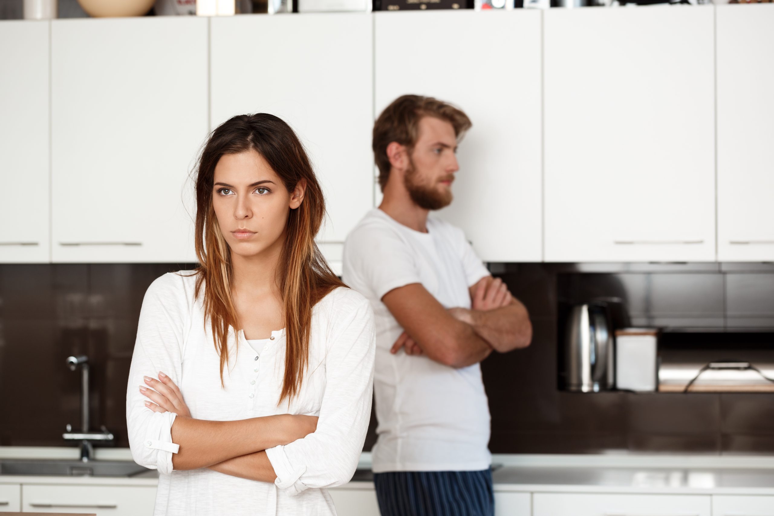 Displeased woman arguing with partner and wondering if bad behaviour will affect their divorce settlement