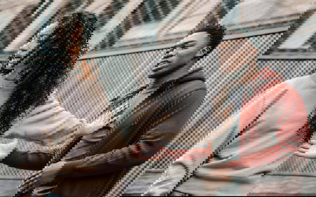 Woman looking distressed while arguing with partner during a high conflict divorce or post separation abuse situation