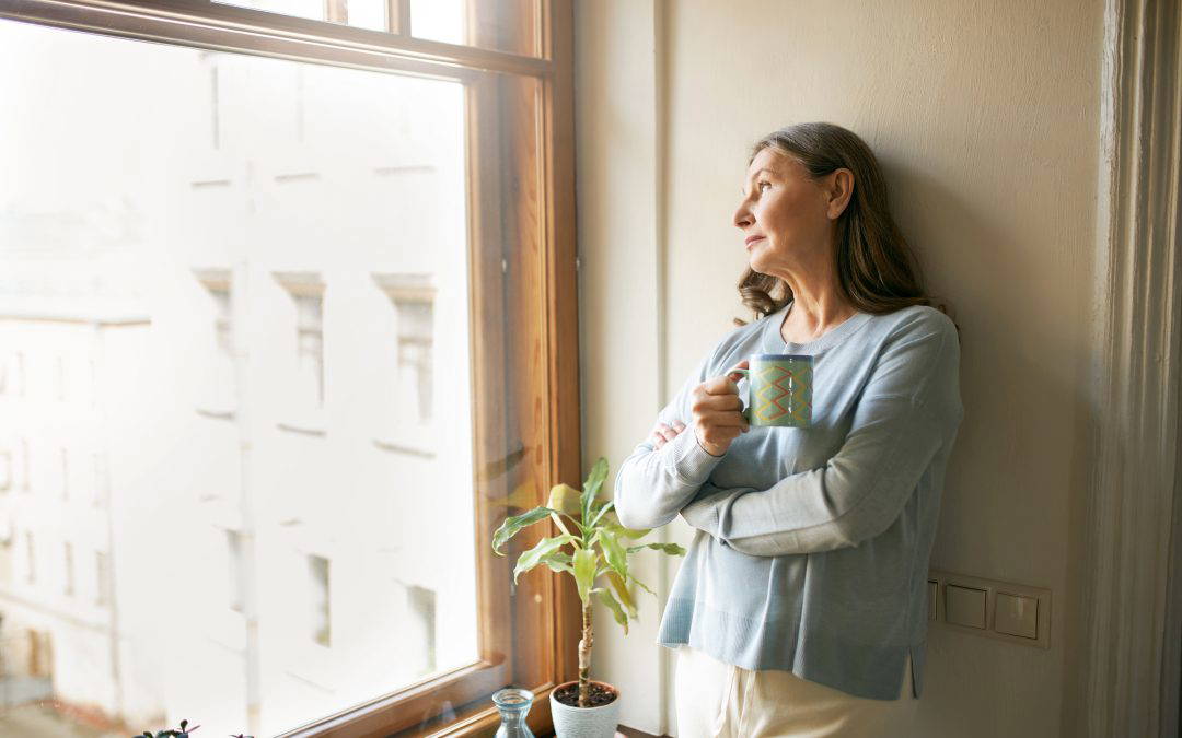Woman looking out of a window wonder how to prepare for divorce