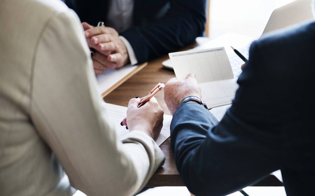 Man and woman signing financial order