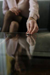 Image of woman taking her ring off and putting it on the table for the blog What are my rights after separation?