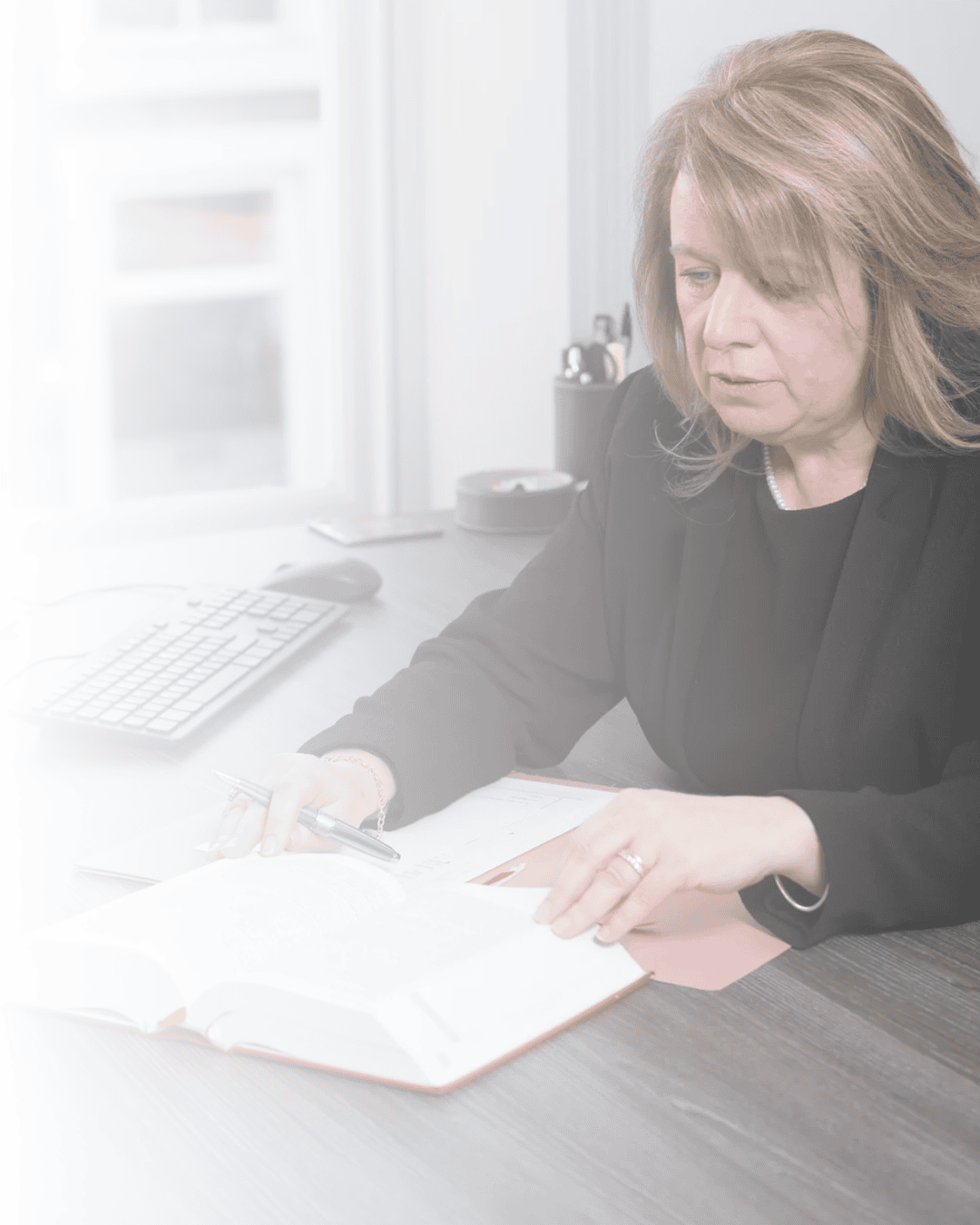 Image of Jacquie Birkett, a domestic abuse solicitor in Bury, at her desk